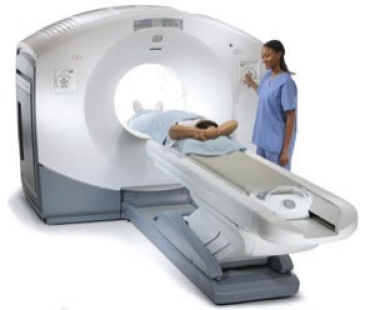 image of PET scan machine with patient and technician